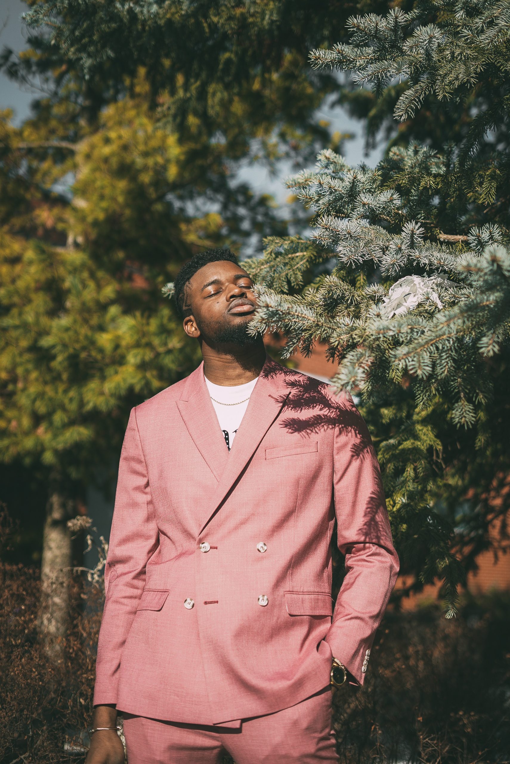 man-in-pink-suit-standing-near-green-tree-3856979-scaled-1